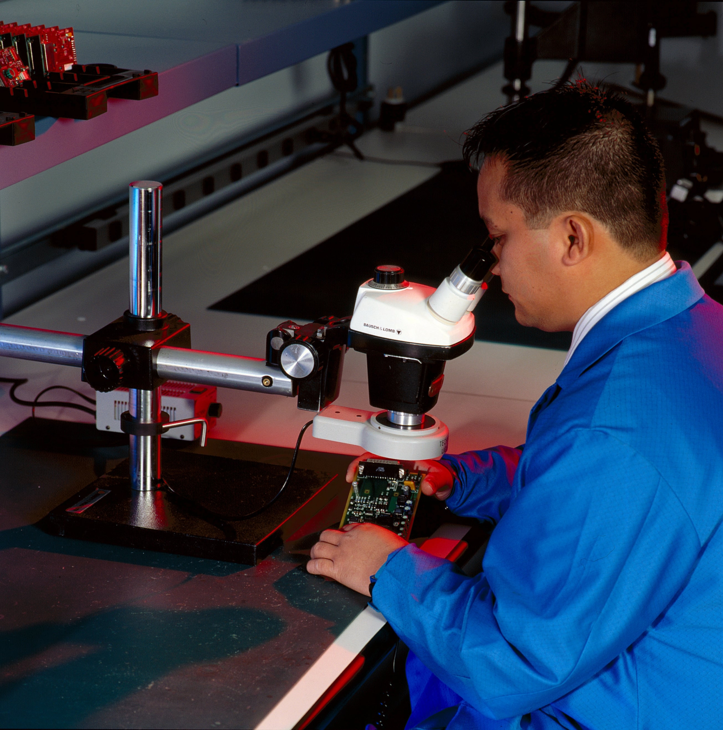 Air Data avionic expert working with a microscope